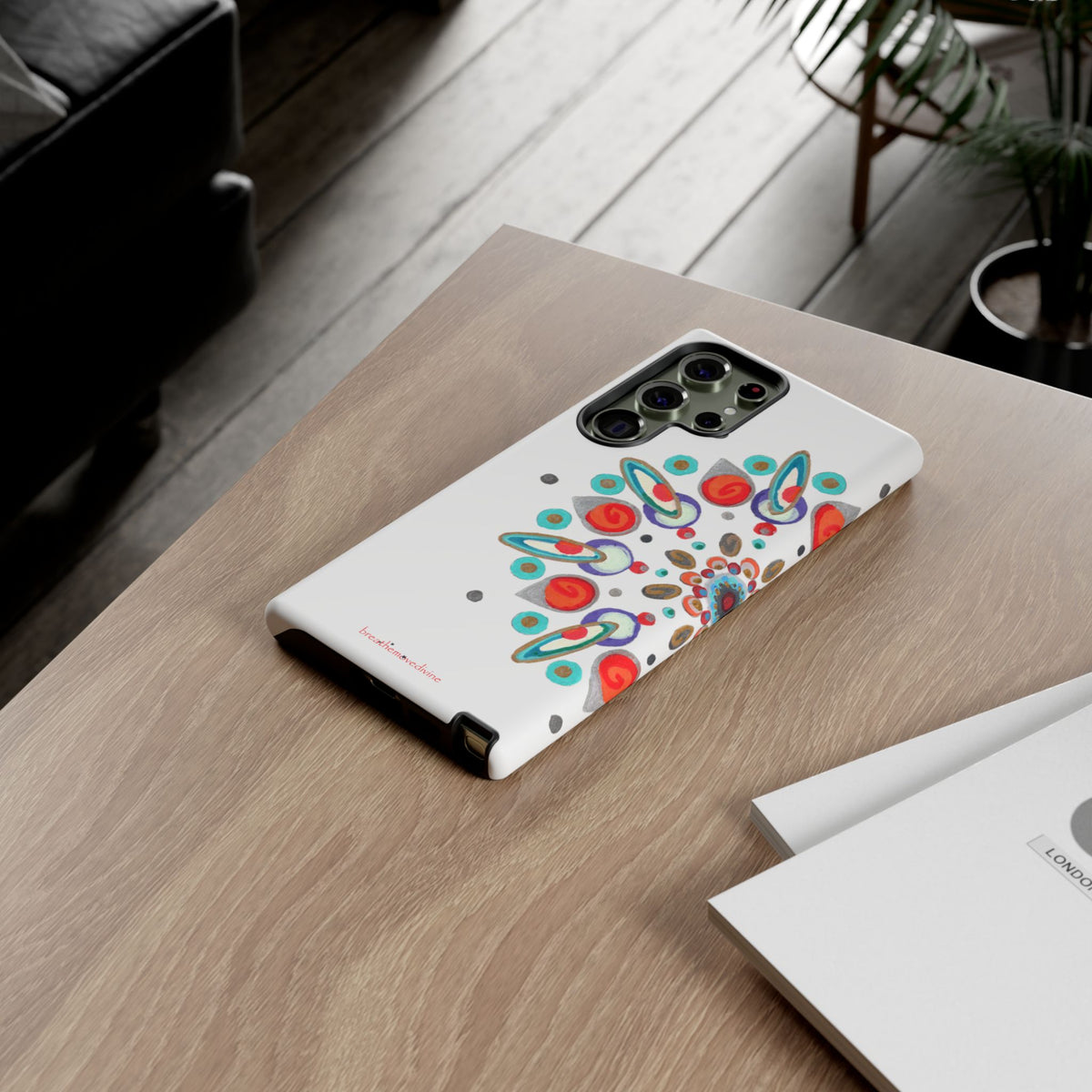 Phone case with colorful design on a wooden table