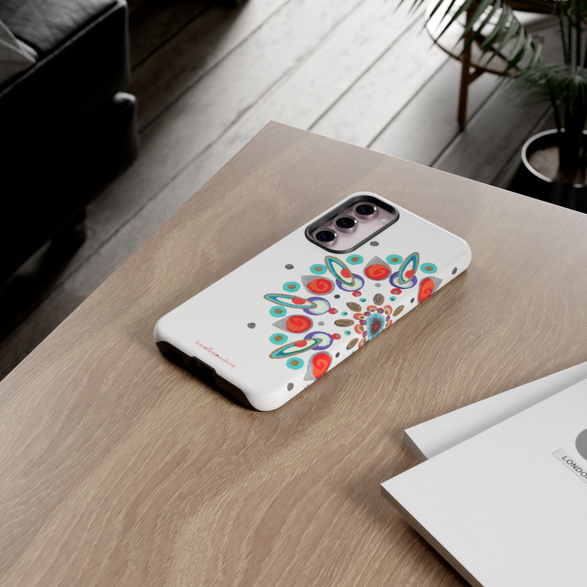 Phone case with colorful design on a wooden table