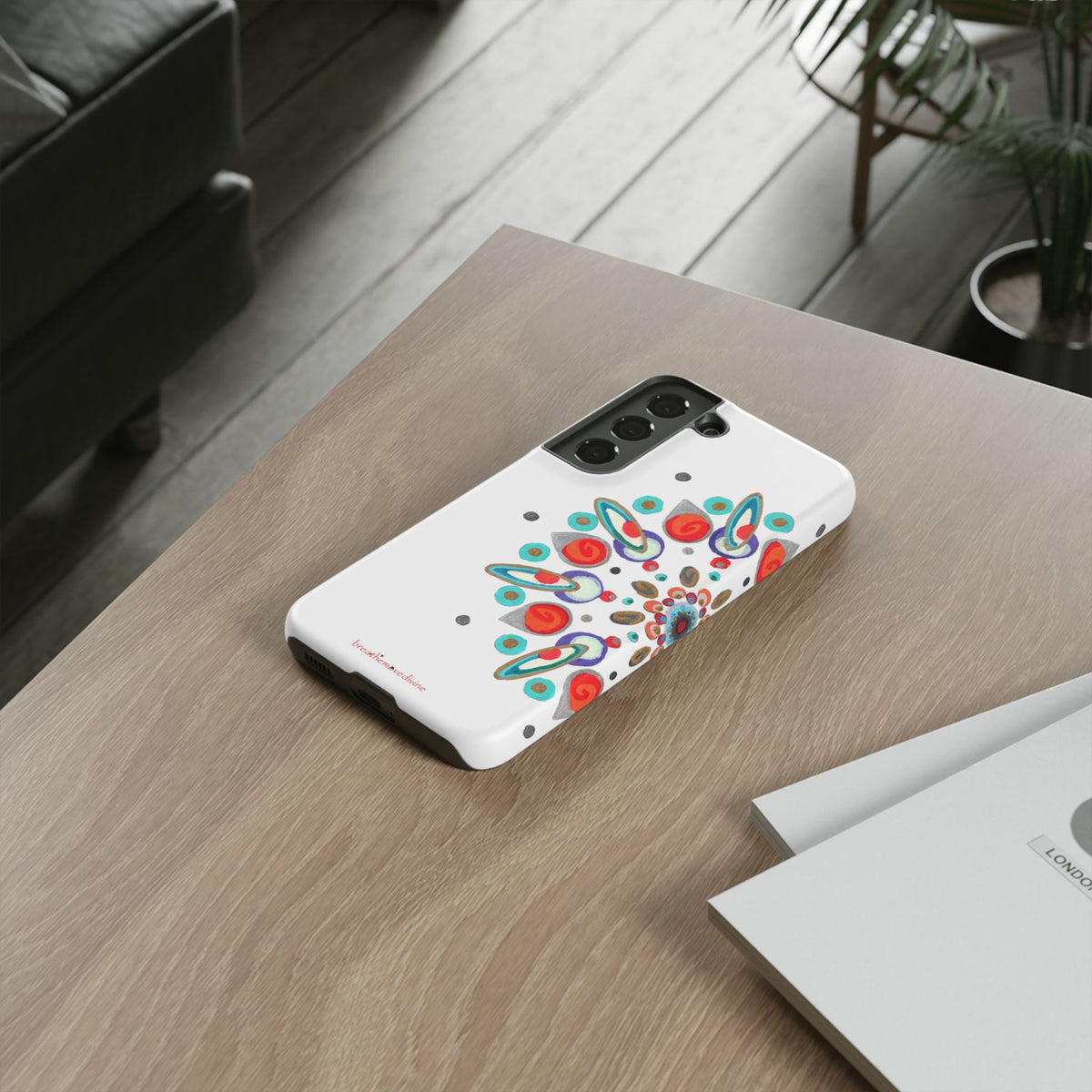 Phone case with colorful design on a wooden table