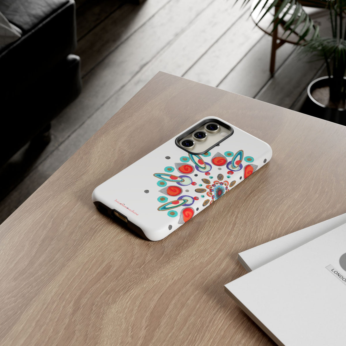 Phone case with colorful design on a wooden table