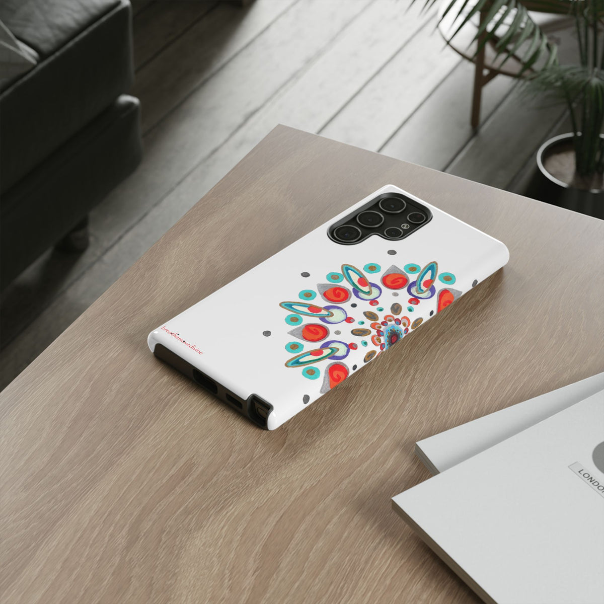 Phone case with colorful design on a wooden table